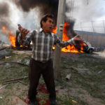 An Afghan man reacts at the site of a blast in Kabul, Afghanistan