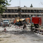 Afghan officials inspect outside the German embassy after a blast in Kabul, Afghanistan