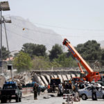 Afghan officials inspect at the site of a blast in Kabul, Afghanistan