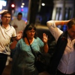 People leave the area with their hands up after an incident near London Bridge in London