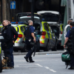 Armed police stand outside Borough Market after an attack left 6 people dead and dozens injured in London