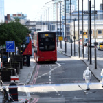Police forensics investigators work on London Bridge near abandoned buses after an attack left 6 people dead and dozens injured in London