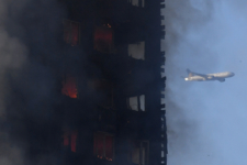 Flames and smoke billow as firefighters deal with a serious fire in a tower block at Latimer Road in West London