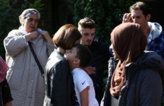 A woman comforts a boy after a tower block was severly damaged by a serious fire, in north Kensington, West London