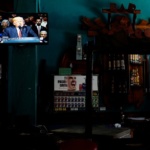 U.S. President Donald Trump is seen on a TV screen announcing his Cuba policy in a state-run bar in Havana